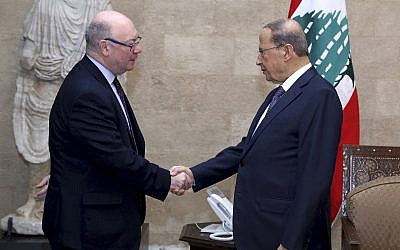 Lebanese President Michel Aoun, right, shakes hands with Britain's Foreign Office Minister Alistair Burt, at the presidential palace, in Beirut, Lebanon, March 7, 2019. (Dalati Nohra via AP)