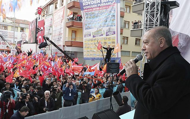 Turkey's President Recep Tayyip Erdogan addresses supporters of his ruling Justice and Development Party (AKP) during a rally in Ankara, Turkey, March 13, 2019. (Presidential Press Service via AP, Pool)