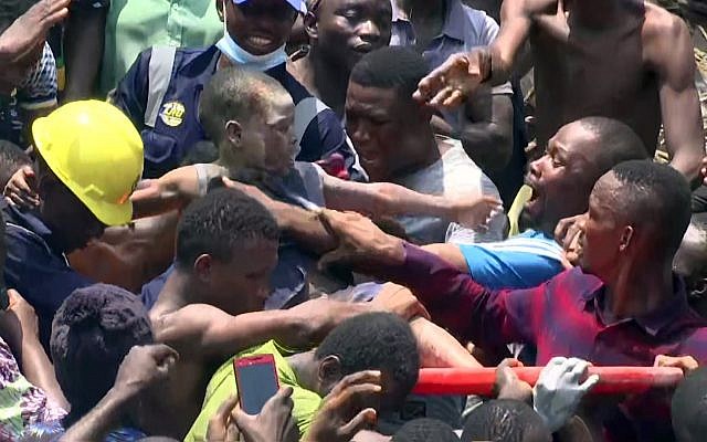 People help a child rescued from the rubble of a three-story school building that collapsed in Lagos, Nigeria, Wednesday March 13, 2019. (AP Photo) People help a child rescued from the rubble of a three-story school building that collapsed in Lagos, Nigeria, Wednesday March 13, 2019. (AP Photo)