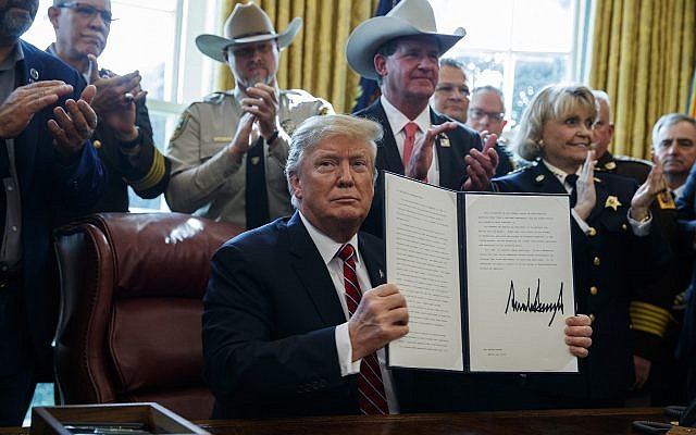 US President Donald Trump signs the first veto of his presidency in the Oval Office of the White House, March 15, 2019, in Washington. (AP Photo/Evan Vucci) US President Donald Trump signs the first veto of his presidency in the Oval Office of the White House, March 15, 2019, in Washington. (AP Photo/Evan Vucci)
