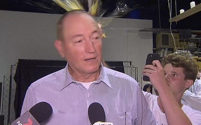 In this image made from video, a teenager breaks an egg on the head of Senator Fraser Anning while he holds a press conference, March 16, 2019, in Melbourne, Australia (AP Photo) In this image made from video, a teenager breaks an egg on the head of Senator Fraser Anning while he holds a press conference, March 16, 2019, in Melbourne, Australia (AP Photo)