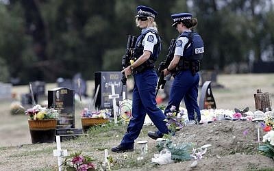 Armed police patrol a cemetery near Muslim graves in Christchurch, New Zealand, March 18, 2019. (AP/Mark Baker)