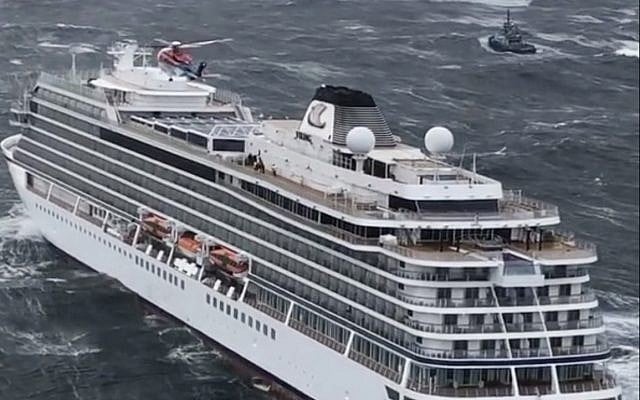 A rescue helicopter flies over the cruise ship Viking Sky evacuating 1,300 passengers and crew amid stormy seas after it sent out a mayday signal due to engine failure, March 23, 2019. (CHC helicopters via AP) A rescue helicopter flies over the cruise ship Viking Sky evacuating 1,300 passengers and crew amid stormy seas after it sent out a mayday signal due to engine failure, March 23, 2019. (CHC helicopters via AP)