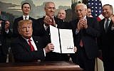 US President Donald Trump holds up a signed proclamation recognizing Israel's sovereignty over the Golan Heights, as Prime Minister Benjamin Netanyahu looks on in the Diplomatic Reception Room of the White House in Washington, March 25, 2019. (AP Photo/Susan Walsh)