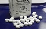 Illustrative: This file photo from February 19, 2013, shows OxyContin pills arranged for a photo at a pharmacy in Montpelier, Vermont. (AP Photo/Toby Talbot, File)