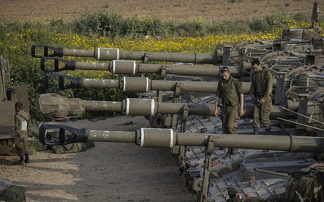 Israeli soldiers sit on top of mobile artillery near the border with the Gaza Strip, in southern Israel, March 27, 2019. (AP Photo/Tsafrir Abayov)