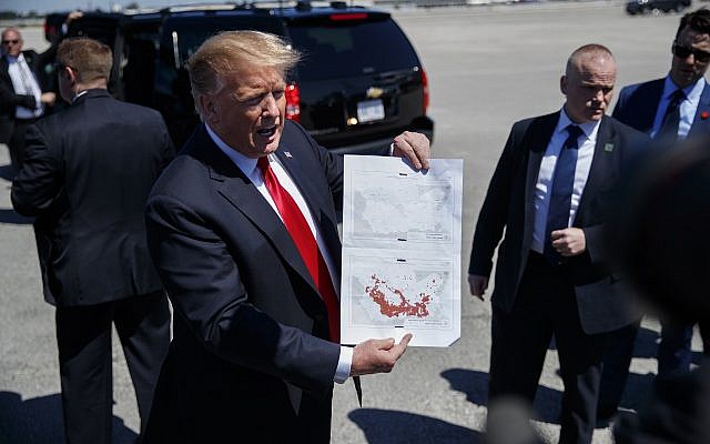 FILE - In this March 22, 2019, photo, President Donald Trump holds a a copy of two maps of Syria as he arrives on Air Force One at Palm Beach International Airport, in West Palm Beach, Florida (AP Photo/Carolyn Kaster) FILE - In this March 22, 2019, photo, President Donald Trump holds a a copy of two maps of Syria as he arrives on Air Force One at Palm Beach International Airport, in West Palm Beach, Florida (AP Photo/Carolyn Kaster)