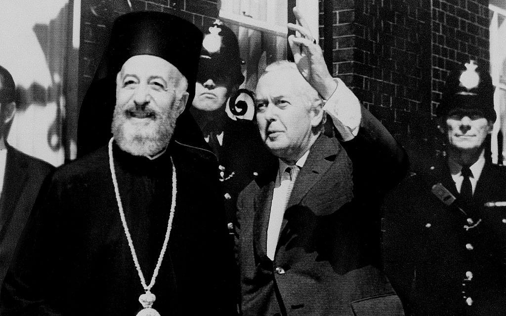 Illustrative: British prime minister Harold Wilson, right, waves to the media as he and Archbishop Makarios, deposed Cyprus president, pose with photographers outside No. 10 Downing Street in London, July 17, 1974.  (AP Photo)