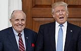Then-president-elect Donald Trump calls out to media as he and former New York mayor Rudy Giuliani pose for photographs as Giuliani arrives at the Trump National Golf Club Bedminster clubhouse, November 20, 2016, in Bedminster, New Jersey. (AP Photo/Carolyn Kaster)