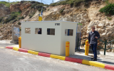 A protective barrier installed at a bus stop at the Givat Assaf Junction on March 20, 2019. (Menachem Bakush)