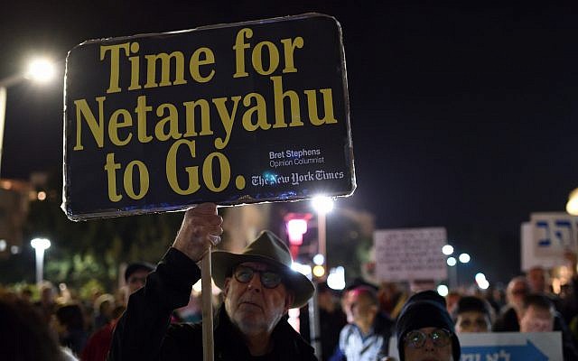 An Israeli man carries a sign citing conservative New York Times opinion columnist Bret Stephens as hundreds protest against Prime Minister Benjamin Netanyahu, Tel Aviv, March 02, 2019 (Gili Yaari/Flash90) An Israeli man carries a sign citing conservative New York Times opinion columnist Bret Stephens as hundreds protest against Prime Minister Benjamin Netanyahu, Tel Aviv, March 02, 2019 (Gili Yaari/Flash90)
