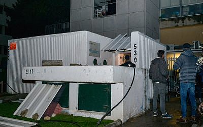 People standing outside a bomb shelter after it was opened by the Tel Aviv municipality on March 14, 2019, after earlier two rockets from the Gaza Strip were fired toward central Israel. (Adam Shuldman/Flash90)