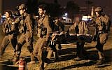 Israeli soldiers evacuate a wounded guard of the Israel Prison Service to Soroka Hospital in Beersheba, southern Israel, on March 24, 2019. (Meir Even Haim/Flash90)