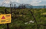 A warning sign of a minefield near the Syrian-Israeli border in the Golan Heights, on March 25, 2019. (Basel Awidat/Flash90)