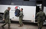 Israeli soldiers get out of a bus as they arrive to the Israel-Gaza border region of southern Israel on March 25, 2019. (Hadas Parush/Flash90)