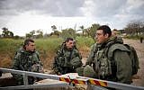 Israeli soldiers stand guard on a road near the Israel-Gaza border in southern Israel, on March 25, 2019. (Hadas Parush/Flash90)
