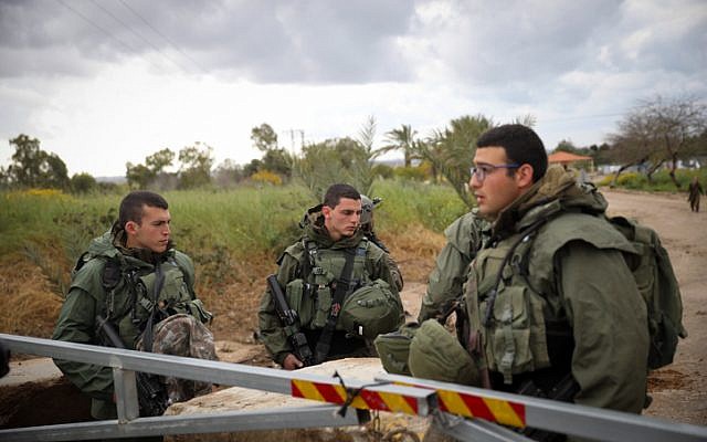 Israeli soldiers stand guard on a road near the Israel-Gaza border in southern Israel, on March 25, 2019. (Hadas Parush/Flash90) Israeli soldiers stand guard on a road near the Israel-Gaza border in southern Israel, on March 25, 2019. (Hadas Parush/Flash90)
