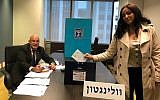 Anat Amichai, the wife of the head of security at Israel's embassy in Wellington, New Zealand, casting the first vote in the elections for the 21th Knesset, in early polling allowed for diplomats and their families, March 28, 2019. (Israel Foreign Ministry)