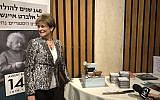 Karen Cortell Reisman, Albert Einstein's cousin, cuts a cake on March 6 in honor of the scientist's 140th birthday and the new papers revealed by the Einstein Archives at Hebrew University (Jessica Steinberg/Times of Israel)