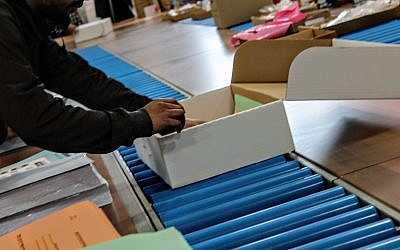 Central Election Committee workers prepare materials to be sent to polling stations ahead of election day, March 6, 2019. (Raoul Wootliff/Times of Israel)