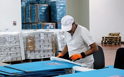 Central Election Committee workers prepare materials to be sent to polling stations ahead of election day, March 6, 2019. (Raoul Wootliff/Times of Israel)