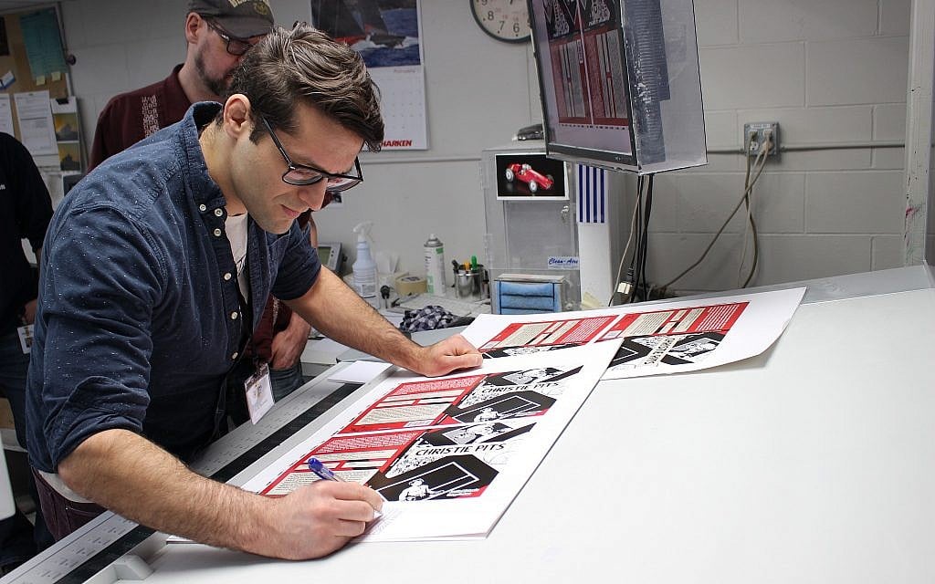 Author Jamie Michaels (foreground) and illustrator Doug Fedrau working on 'Christie Pits' at Friesens in Altona, Manitoba. (Alex Michaels)