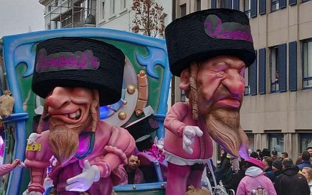 A parade float at the Aalst Carnaval in Belgium featuring caricatures of Orthodox Jews atop money bags, March 3, 2019. (Courtesy of FJO, via JTA) A parade float at the Aalst Carnaval in Belgium featuring caricatures of Orthodox Jews atop money bags, March 3, 2019. (Courtesy of FJO, via JTA)