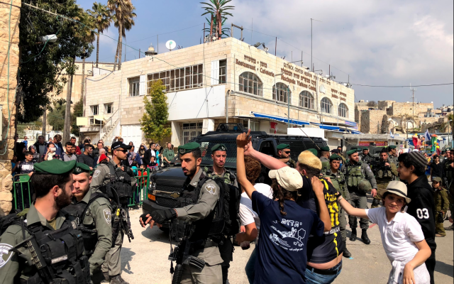 Israelis in Hebron parade through the streets in celebration of the Purim holiday on March 21, 2019. (Jacob Magid/Times of Israel) Israelis in Hebron parade through the streets in celebration of the Purim holiday on March 21, 2019. (Jacob Magid/Times of Israel)