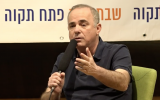 Energy Minister Yuval Steinitz speaks during an on-stage interview in Petah Tikva on March 30, 2019. (Screen capture/Channel 13)