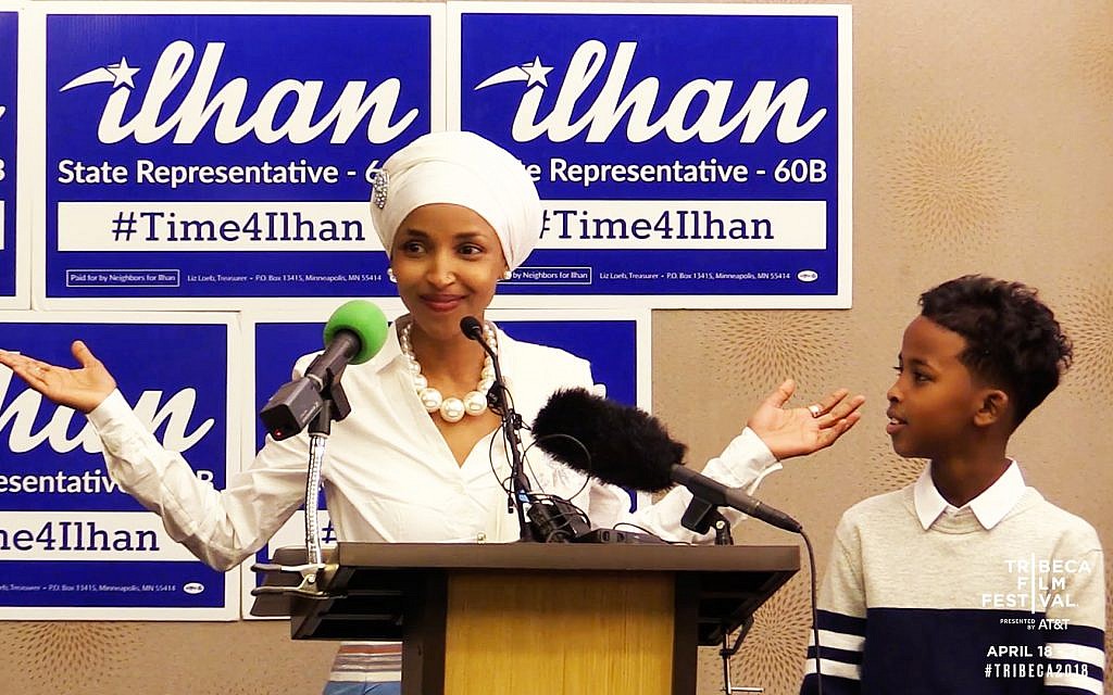 Then candidate for Minnesota Rep. Ilhan Omar campaigning in front of '#Time4Ilhan' posters. (Courtesy Norah Shapiro/ Chris Newberry) Then candidate for Minnesota Rep. Ilhan Omar campaigning in front of '#Time4Ilhan' posters. (Courtesy Norah Shapiro/ Chris Newberry)
