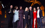 Designers honored at '70 Years of Israeli Fashion' at the Expo Tel Aviv on March 5 included Gideon Oberson (third from right) and Ronen Chen (far right) with Culture and Sport Minister Miri Regev (third from left) and Sara Netanyahu (center, in black dress) (Courtesy Sivan Farag)