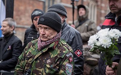 A man taking part in a march to honor member of the Latvian Legion SS units in Riga, Latvia, on March 16, 2019. (Courtesy: JFDA e.V. / Grischa Stanjek(