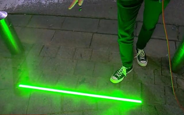 Tel Aviv testing new devices embedded in sidewalk to alert pedestrians when the stoplight has changed. (Screenshot, Channel 12 News) Tel Aviv testing new devices embedded in sidewalk to alert pedestrians when the stoplight has changed. (Screenshot, Channel 12 News)