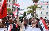 Tunisians hold Syrian and Palestinian flags, as they demonstrate against the Arab League Summit and the United States' recognition of Israeli sovereignty over the Golan Heights, on Habib Bourguiba Avenue, in the capital Tunis on March 31, 2019. (Anis Mili/AFP)