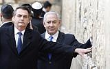 File - Brazilian President Jair Bolsonaro (L) and Prime Minister Benjamin Netanyahu touch the Western Wall in the Old City of  Jerusalem on April 1, 2019. (Menahem Kahana/Pool/AFP)