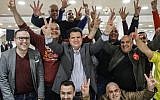 Israeli Arab politician Ayman Odeh (c) of the Hadash party flashes the victory gesture as he reacts at the party's headquarters in Nazareth in northern Israel on election tonight on April 9, 2019. (AFP/Ahmad Gharabli)