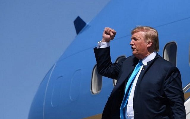US President Donald Trump pumps his fist as he steps off Air Force One upon arrival at Ellington Field Joint Reserve Base in Houston, Texas, on April 10, 2019. (Photo by Jim WATSON / AFP) US President Donald Trump pumps his fist as he steps off Air Force One upon arrival at Ellington Field Joint Reserve Base in Houston, Texas, on April 10, 2019. (Photo by Jim WATSON / AFP)