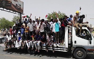 Sudanese men celebrate on April 11, 2019 while rallying in the capital Khartoum. (AFP)