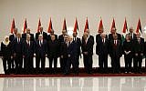 Palestinian Authority President Mahmoud Abbas (6th-right) walks away after posing for a group photograph with members of the new Palestinian Authority government in the West Bank city of Ramallah on April 13, 2019. (Abbas Momani/AFP)