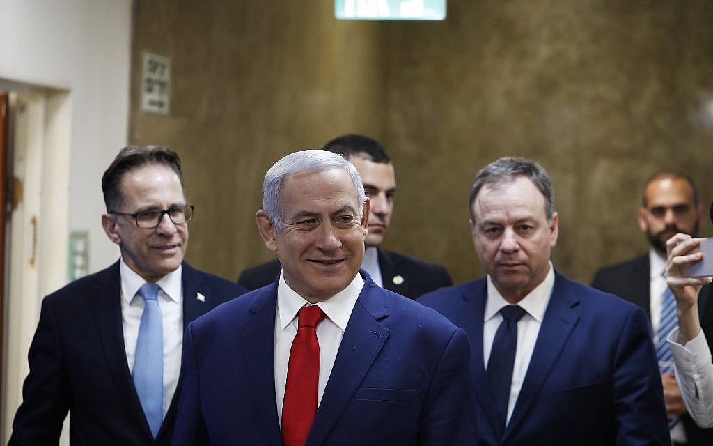 Prime Minister Benjamin Netanyahu (C) arrives for the weekly cabinet meeting at his office in Jerusalem on April 14, 2019. (Ronen Zvulun/AFP)