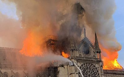 Flames and smoke are seen billowing from the roof at Notre Dame Cathedral in Paris on April 15, 2019.  (Patrick ANIDJAR / AFP)