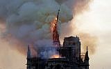 The spire of the landmark Notre Dame Cathedral collapses as the church is engulfed in flames in central Paris on April 15, 2019. (Geoffroy van der Hasselt/AFP)