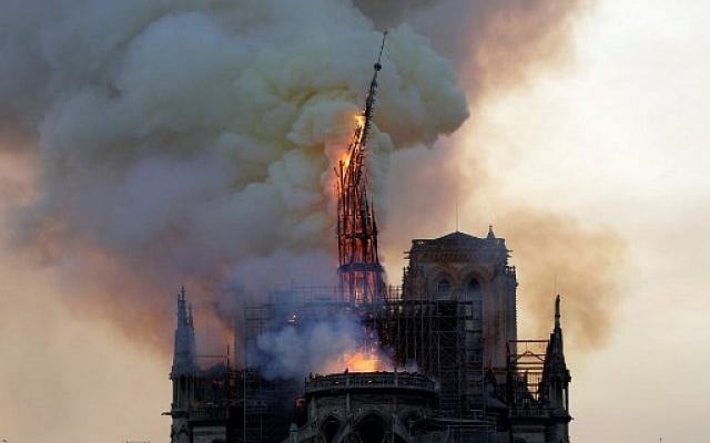 The spire of the landmark Notre Dame Cathedral collapses as the church is engulfed in flames in central Paris on April 15, 2019. (Geoffroy van der Hasselt/AFP) The spire of the landmark Notre Dame Cathedral collapses as the church is engulfed in flames in central Paris on April 15, 2019. (Geoffroy van der Hasselt/AFP)