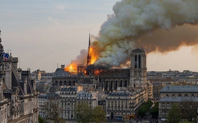 Smoke billows as flames burn through the roof of the Notre-Dame de Paris Cathedral on April 15, 2019, in the French capital Paris. (Fabien Barrau / AFP)