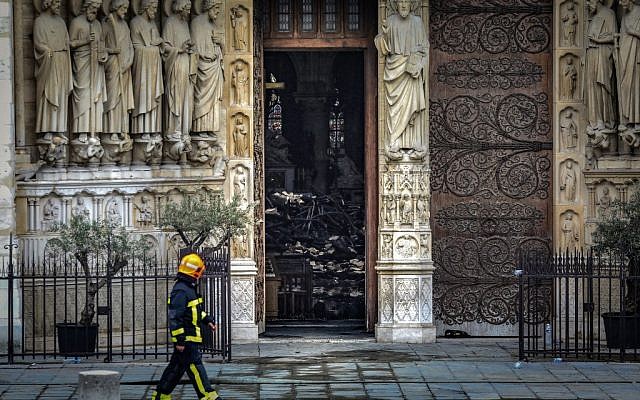 A firefighter walks along Notre-Dame-de Paris on April 16, 2019 in Paris in the aftermath of a fire that devastated the cathedral. ( LUDOVIC MARIN / POOL / AFP) A firefighter walks along Notre-Dame-de Paris on April 16, 2019 in Paris in the aftermath of a fire that devastated the cathedral. ( LUDOVIC MARIN / POOL / AFP)