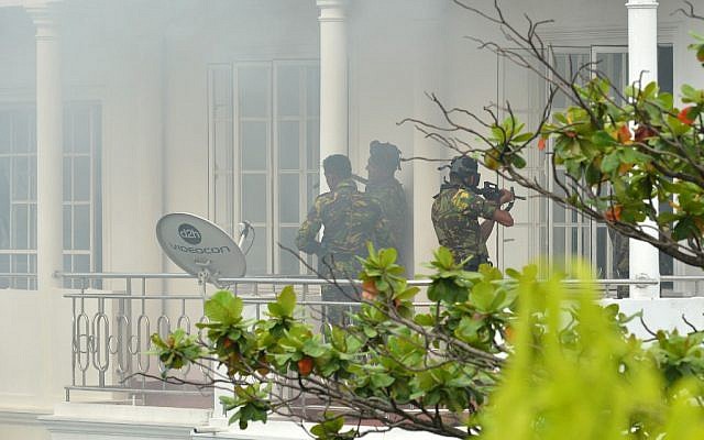 Sri Lankan Special Task Force (STF) personnel are pictured outside a house during a raid -- after a suicide blast killed police officers searching the property -- in the capital Colombo on April 21, 2019, following a series of deadly blasts in churches and hotels. (ISHARA S. KODIKARA / AFP) Sri Lankan Special Task Force (STF) personnel are pictured outside a house during a raid -- after a suicide blast killed police officers searching the property -- in the capital Colombo on April 21, 2019, following a series of deadly blasts in churches and hotels. (ISHARA S. KODIKARA / AFP)