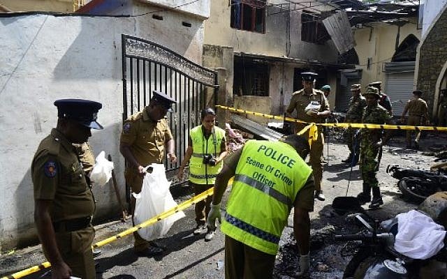 Sri Lankan security personnel and police investigators look through debris outside Zion Church following an explosion in Batticaloa in eastern Sri Lanka on April 21, 2019. (LAKRUWAN WANNIARACHCHI / AFP)