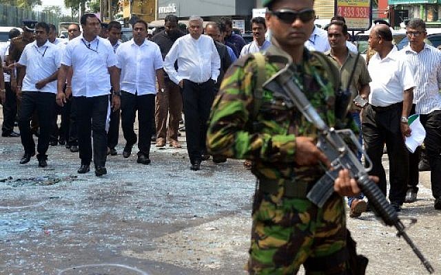 Sri Lankan Prime Minister Ranil Wickremasinghe (C) arrives at the site of a bomb attack at St. Anthony's Shrine in Kochchikade in Colombo on April 21, 2019. (ISHARA S. KODIKARA / AFP)