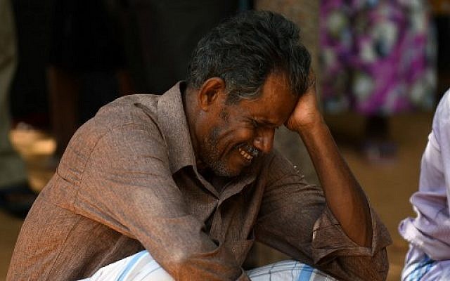 A relative of a Sri Lankan victim of an explosion at a church weeps outside a hospital in Batticaloa in eastern Sri Lanka on April 21, 2019. (LAKRUWAN WANNIARACHCHI / AFP)