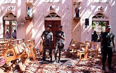 Sri Lankan soldiers look on inside the St Sebastian's Church at Katuwapitiya in Negombo on April 21, 2019, following a bomb blast during the Easter service that killed tens of people. (STR / AFP)